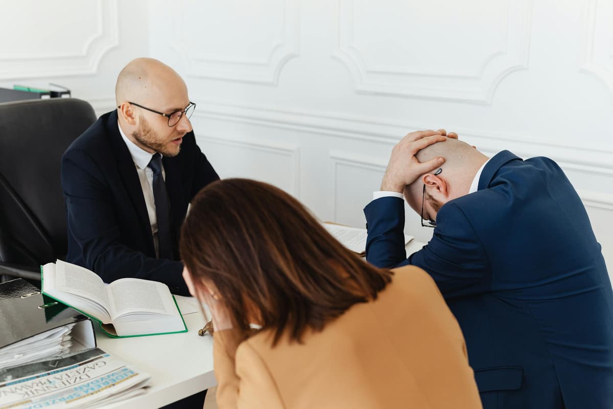 Serious meeting reviewing acquisition deal risks