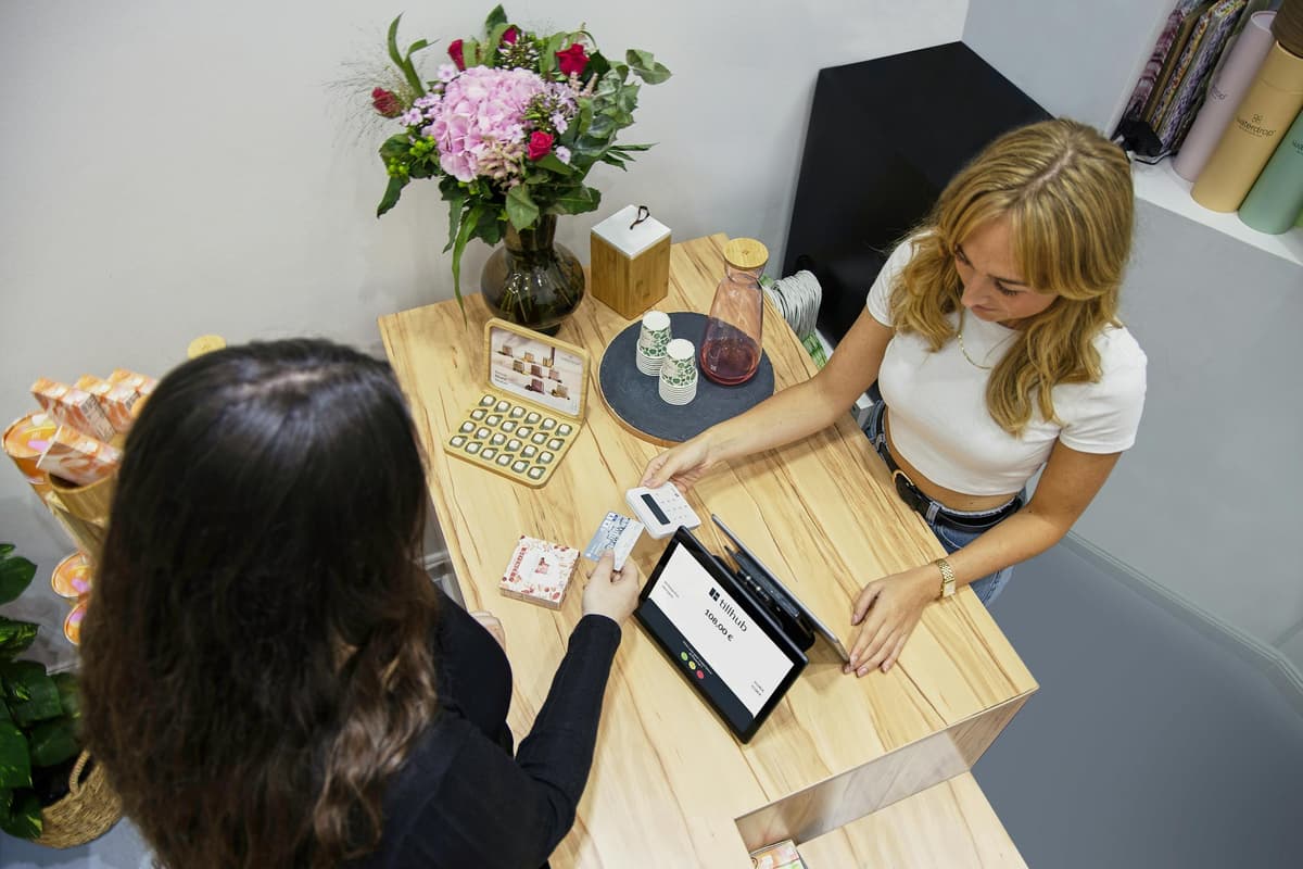 Customer paying at a busy small business